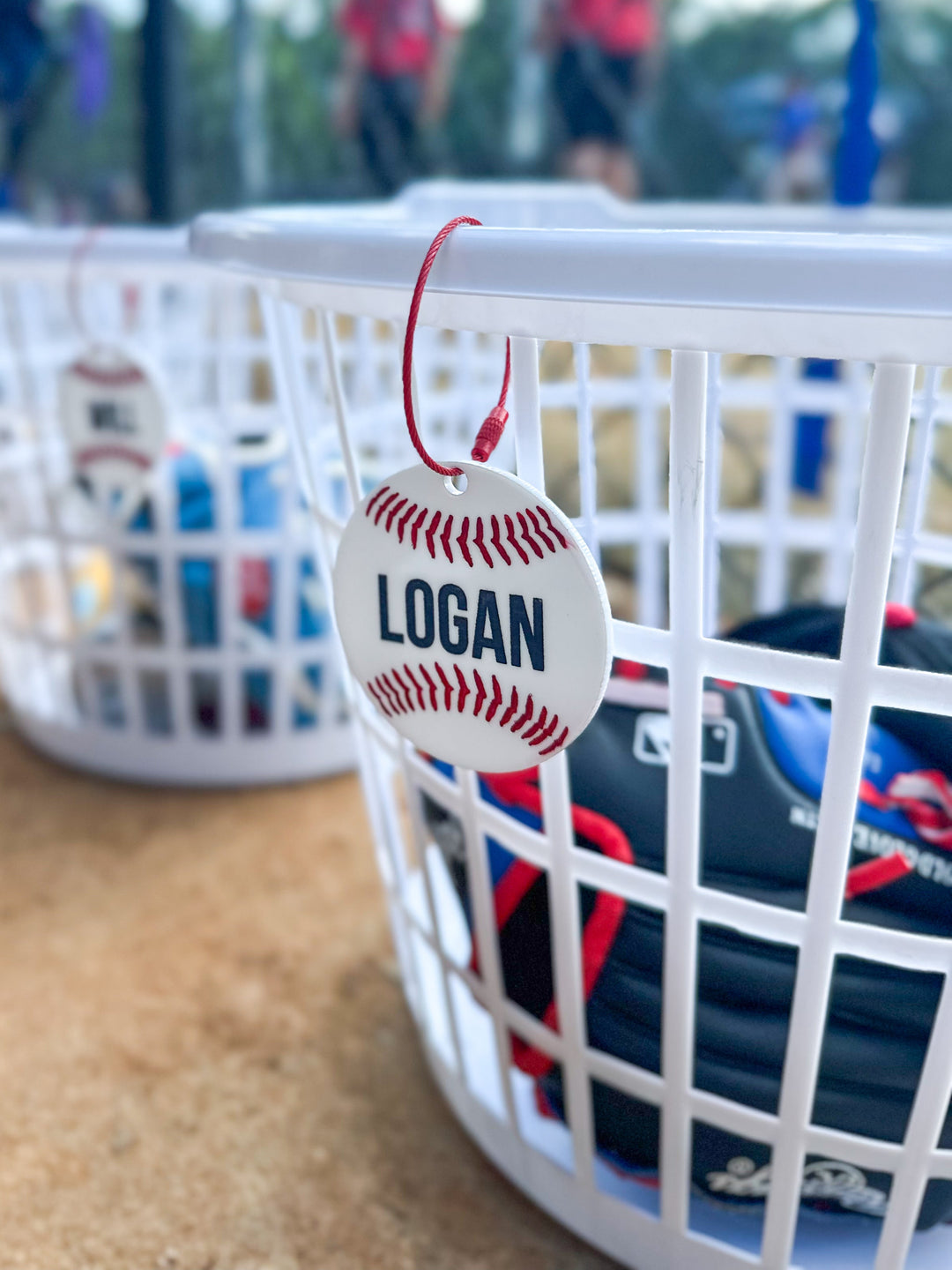 Basket with a tag labeled 'LOGAN' at a sports facility with blurred people in the background